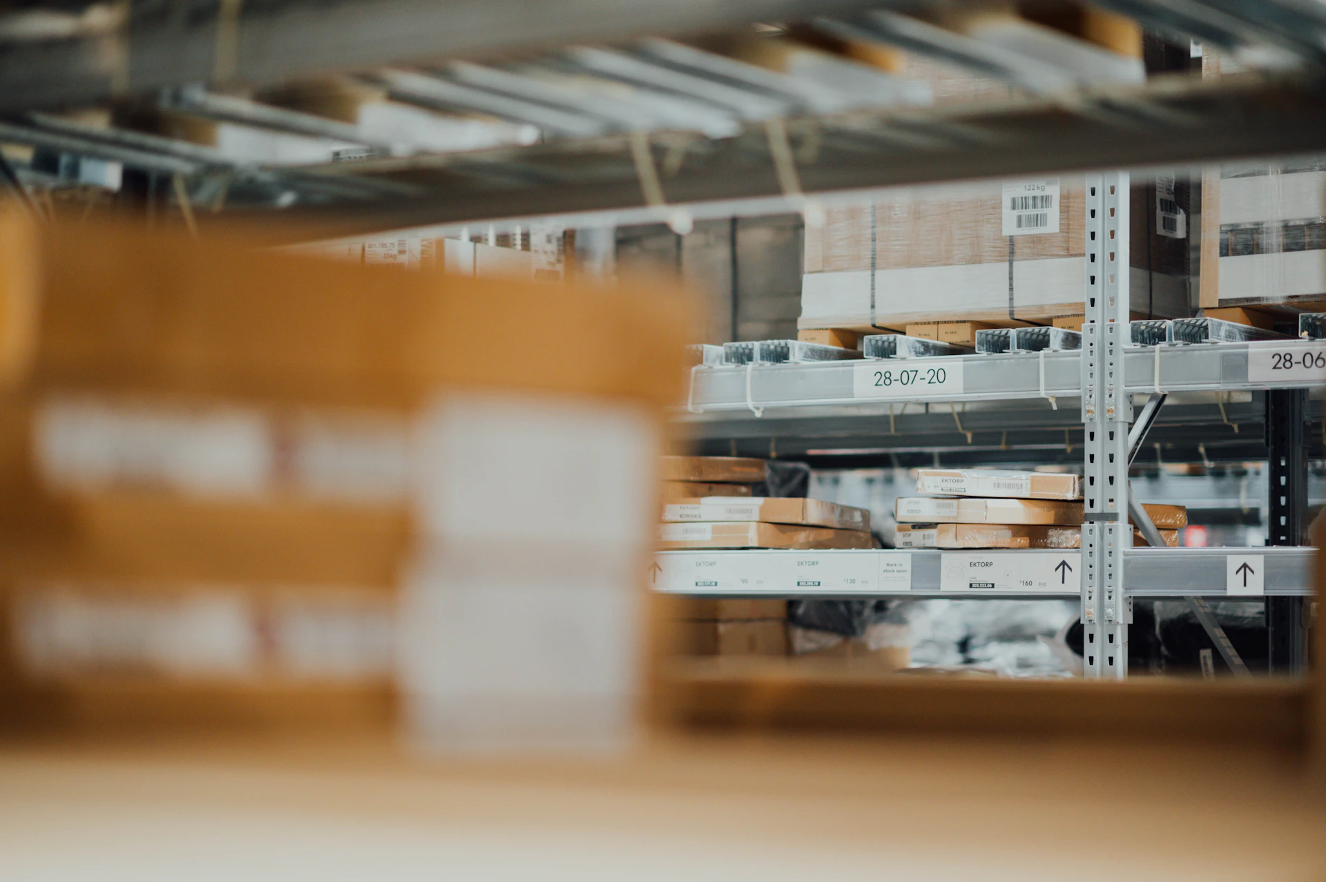Close-up of hands scanning barcodes on pet food packages in a clean, minimal storage area